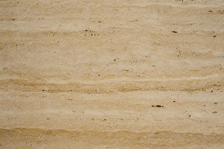 Warm beige travertine surface close-up